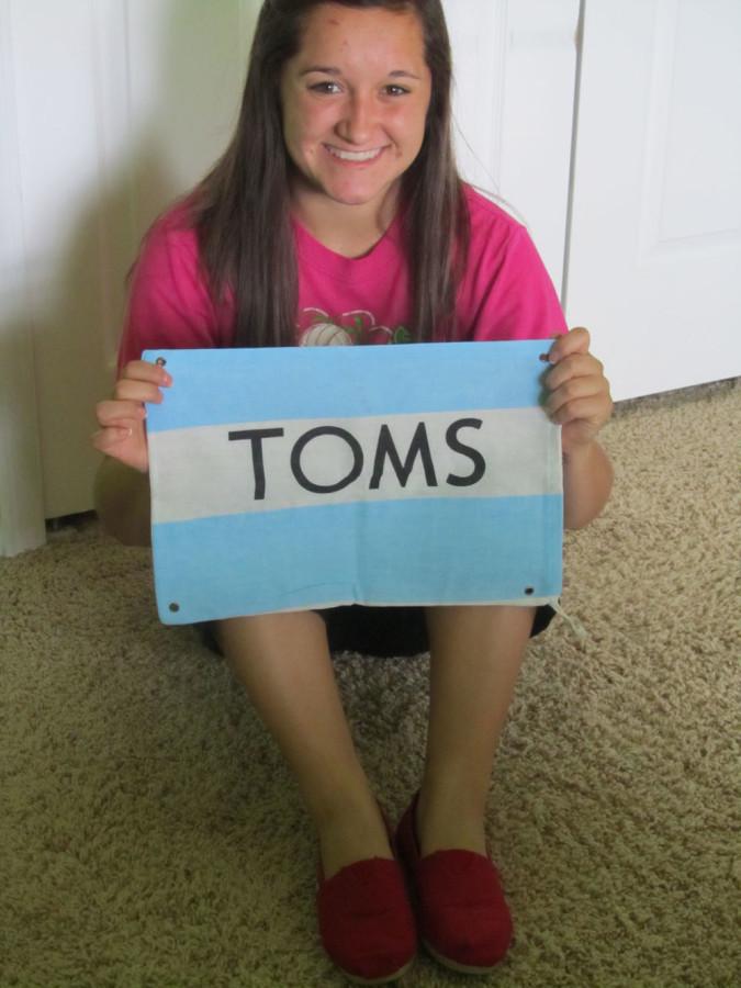 Dana Morse showing pride for Tom's with her shoes and complementary flag.