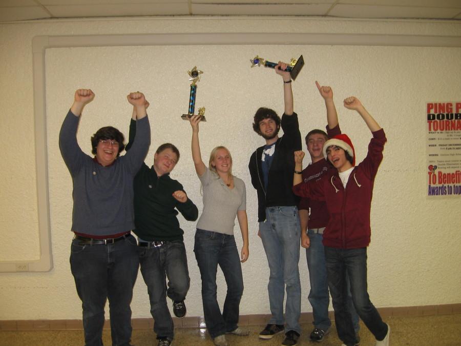 Members of the Milford Quiz Bowl team celebrate after finishing a 15-1 season, winning the Genesee Area League Championship