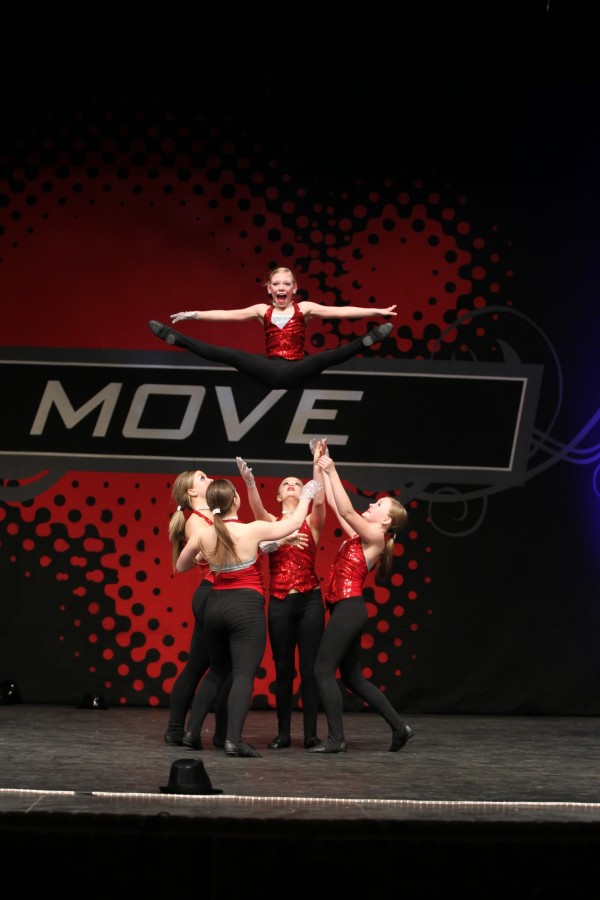 Mackenzie Maney performing with fellow dancers from Milford Dance Academy during a jazz dance.