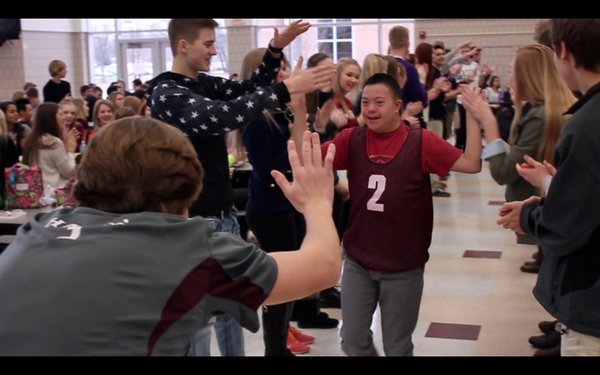 Calvin high fives with other MHS students during last Saturday's Special Olympics Events