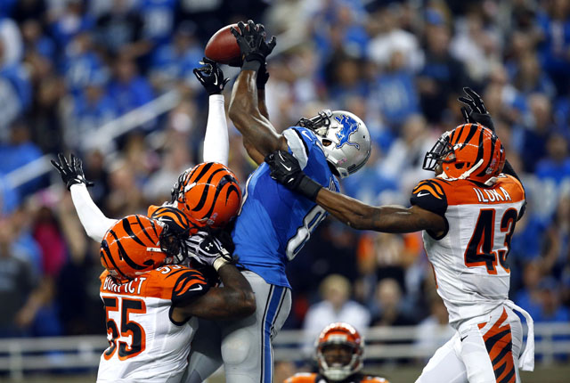Detroit Lions wide receiver Calvin Johnson (81) catches a 50-yard touchdown reception over Cincinnati Bengals outside linebacker Vontaze Burfict (55), free safety Reggie Nelson (20) and strong safety George Iloka (43) in the fourth quarter of an NFL football game against Sunday, Oct. 20, 2013, in Detroit. (AP Photo/Rick Osentoski)