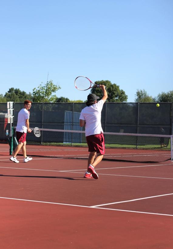 Boys+tennis+team+raising+a+racket
