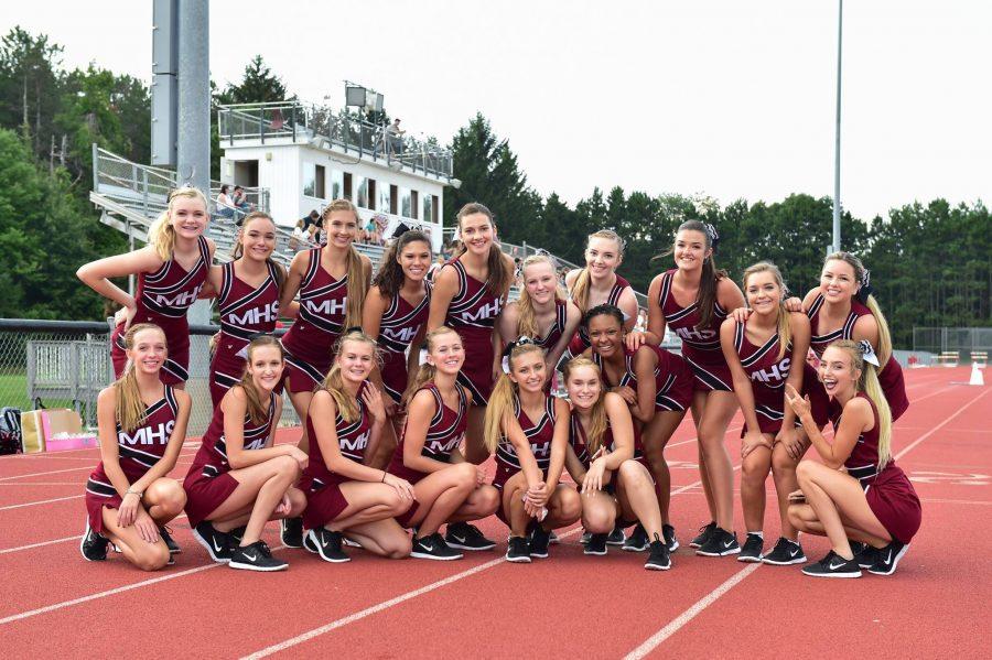 Milford Pom girls standing together for a photo before the home game. 