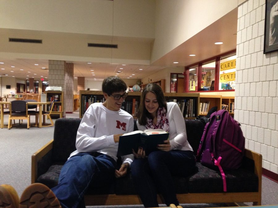 Reid Sellers and Julia Schwendenmann studying in the library.