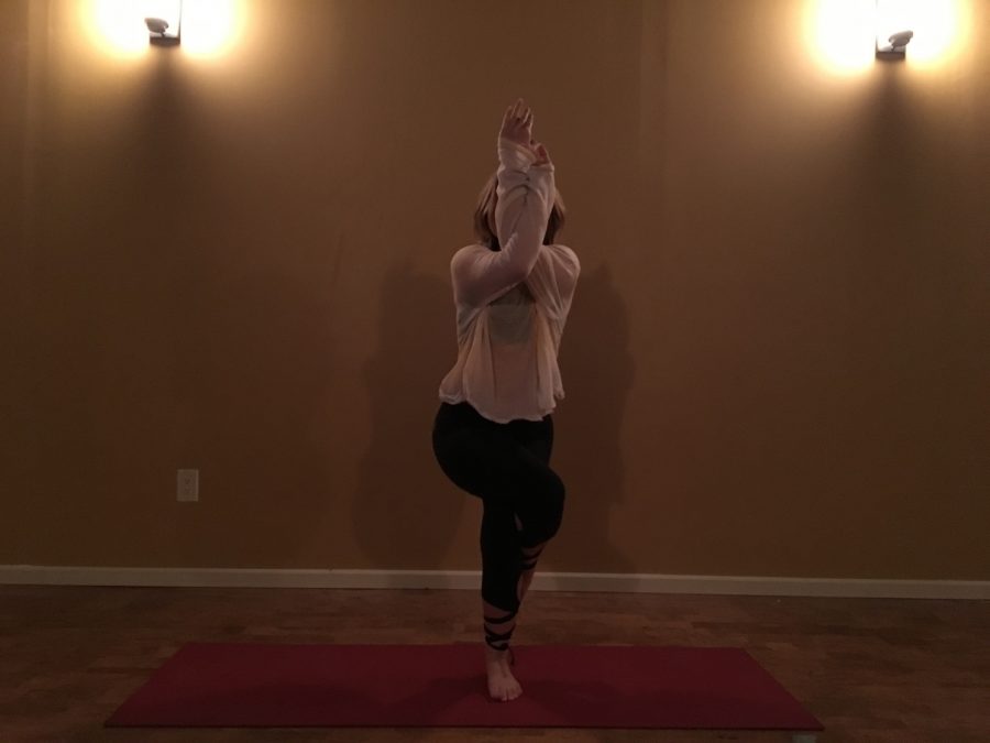 Junior Katy Trame practices Yoga at Harmony Studios in Milford. 