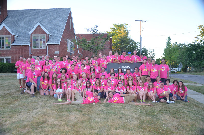 Volunteers in front of Calvary United Methodist Church, posing for a group photograph after a long work day.