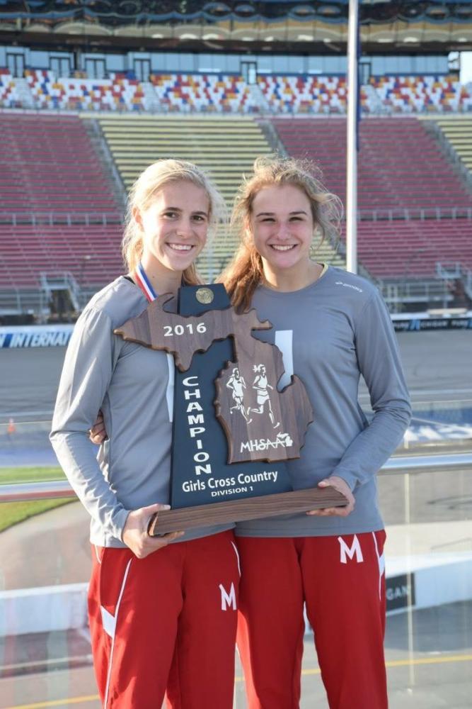 Victoria Heiligenthal and Nicole Grindling proudly holding the state championship trophy.