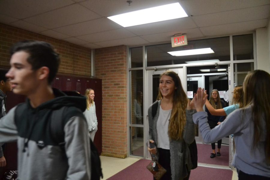 Juniors Sabrina Sajdak and Abby Spindler greeted at student parking lot entrance.