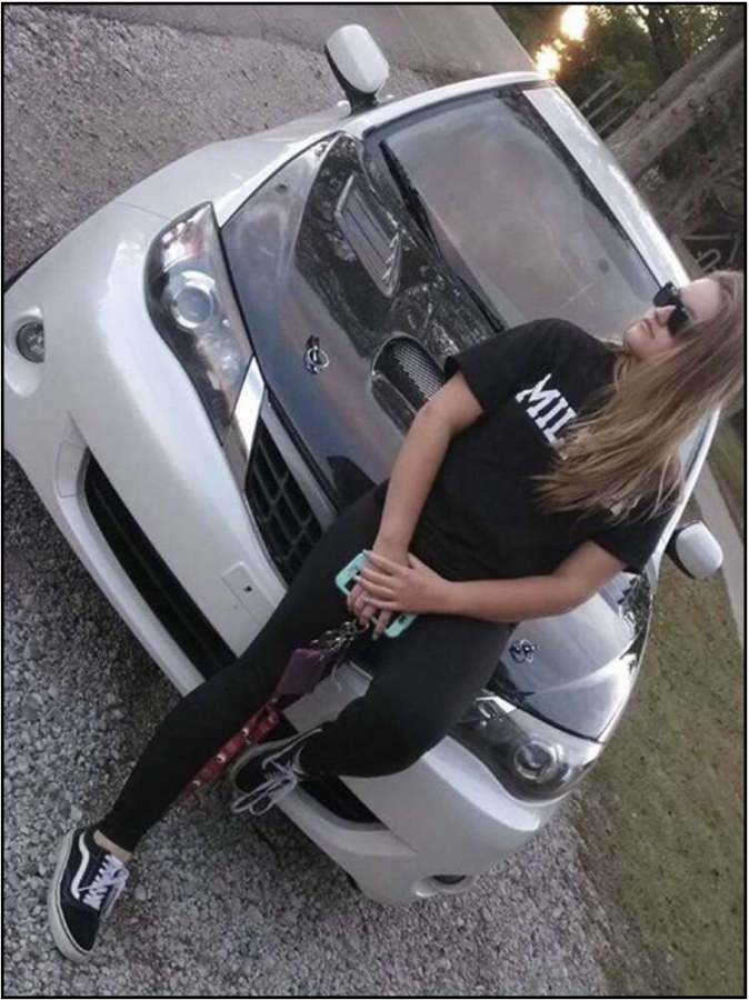 Junior Kelli Miller posing with her 2008 Subaru Impreza 2.5i  
