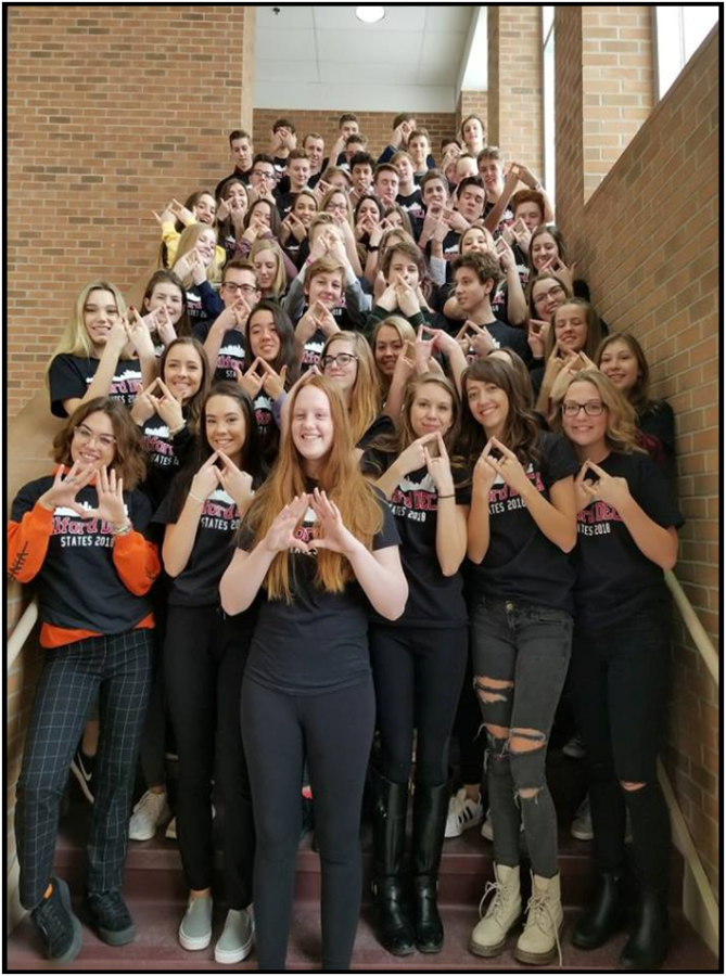 DECA students flashing the DECA diamond before states.