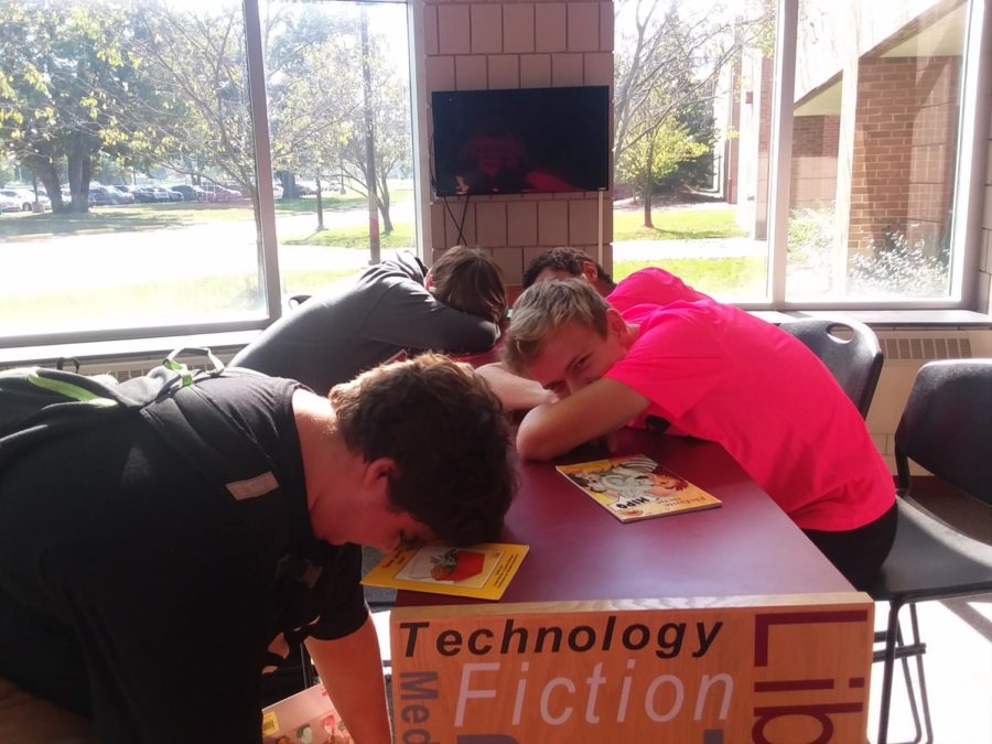 Front to back Alex Leonard, Nolan Preis, Reshaun Crawford, and Michael Pasco
Catch up on their missed sleep in the Media Center.  High school students only average 7-7.5 hours of sleep per night when research shows many students need at least 9 hours per night. (Photo by Jonathon Ouellette.)
