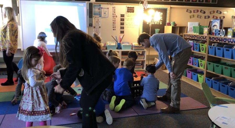 Junior Kayla Pennebaker (left) and senior Trevor Hoppe (right) spending the day working with kindergarteners at Johnson Elementary. (Photos by Abby Knapp)  
