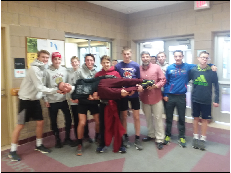 The Milford winter track and field team about to go for a run on a nice and chilly afternoon, with Brian Salyers (Photo by Jonathon Ouellette)
