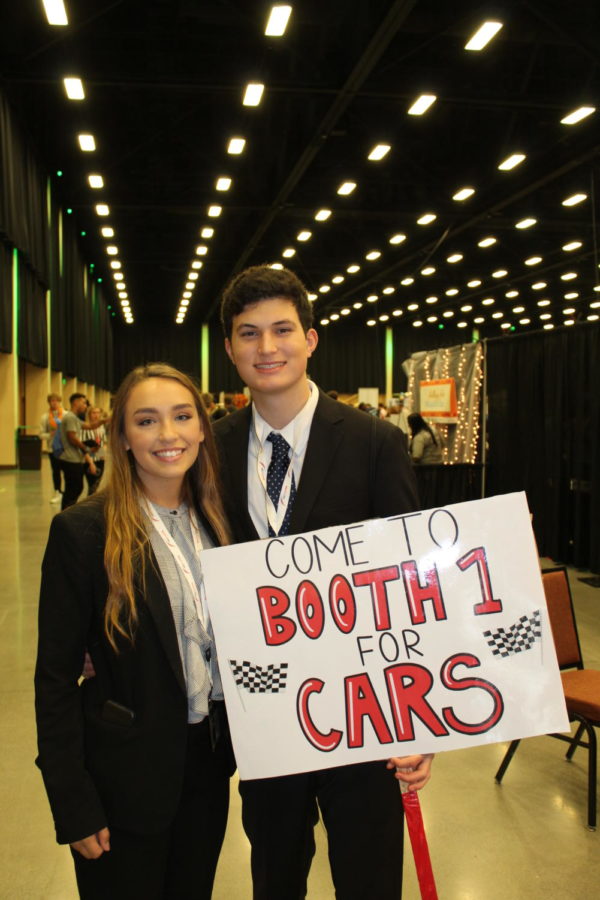 Seniors+Alexis+Camilleri+and+Austin+Maiberger+advertising+the+cars+on+a+poster+Austin+drew.+