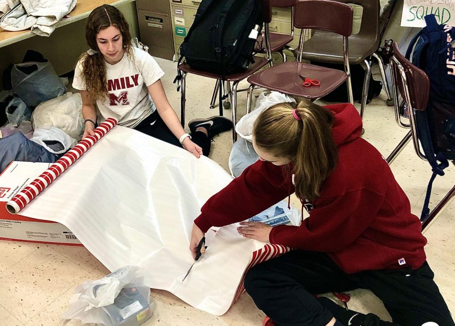 Leadership members Rachel Maude and Kayla Leatch wrapping gifts to deliver to the less fortunate. (Photo by Annabel Williamson)