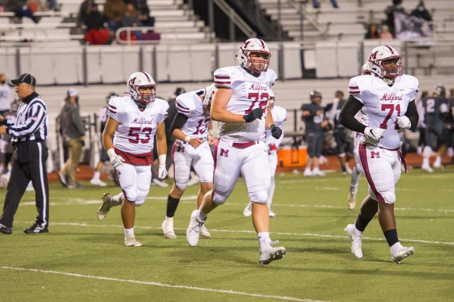 Milford Mavericks Trevor Leigh (Center) running off the field. Along with Victor Elicerio (Left) and Donte Taylor (Right). 