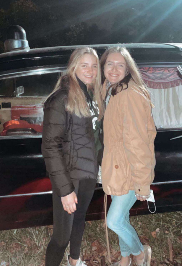 Senior Jackie Smith and Sophomore Megan Sclabassi posed in front of the entrance to the haunted forest.