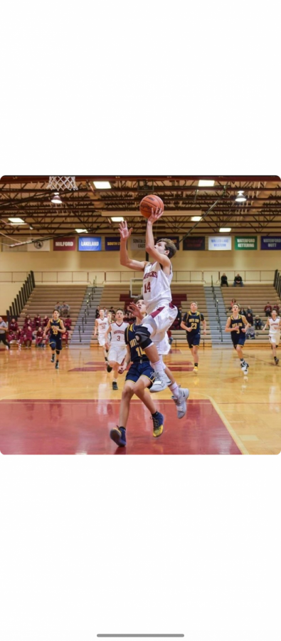 Depicted here is Senior Seb Naughton during a basketball game last season; he is looking forward to returning to the court this year to play with other seniors on the team. 