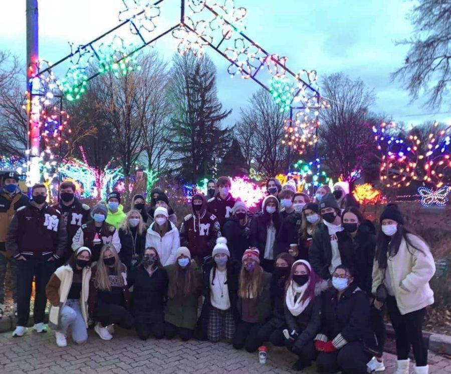 Milford seniors, donned in masks, enjoy an evening at the zoo with their classmates.