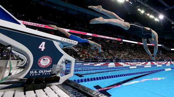 Olympic striving athletes about to enter the water.