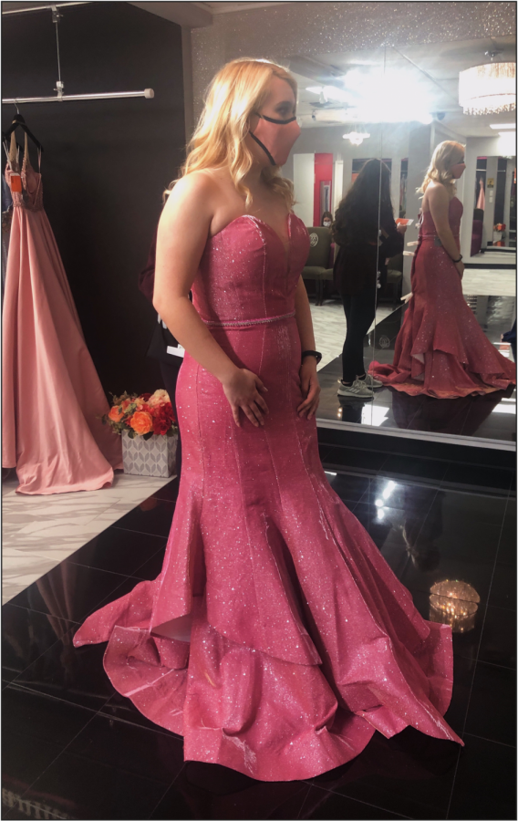 Milford High School Senior Jenna Natwick tries on a dress for prom, which is scheduled for Friday, May 28 at the Suburban Showplace in Novi.