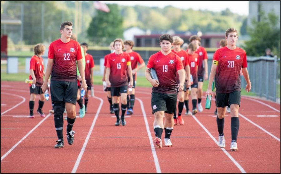 The Varsity team enters the field. Front row from left to right Joey Deep, Alex Poti, and Matthew Mrozinski 