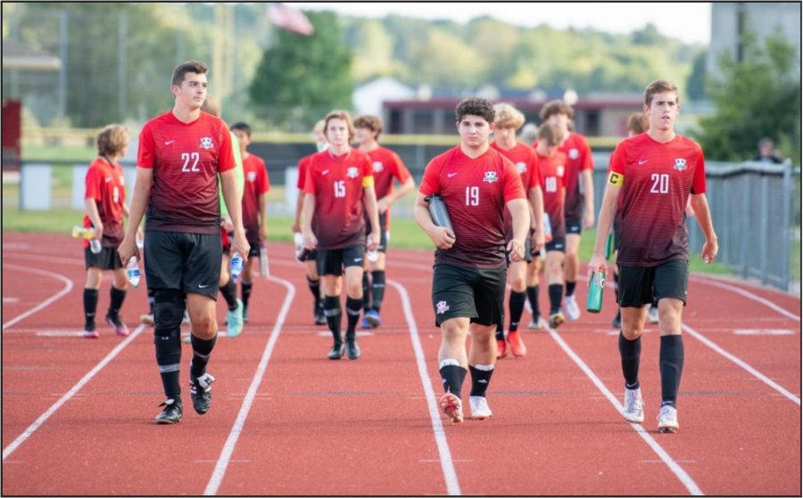 The+Varsity+team+enters+the+field.+Front+row+from+left+to+right+Joey+Deep%2C+Alex+Poti%2C+and+Matthew+Mrozinski+