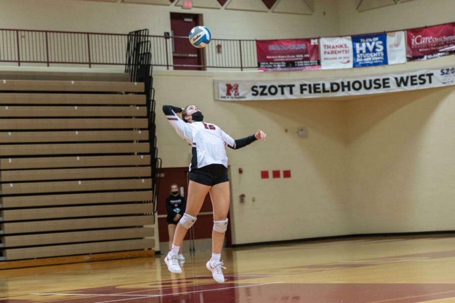 Junior Sarah Rand serves during the 2021 volleyball season.