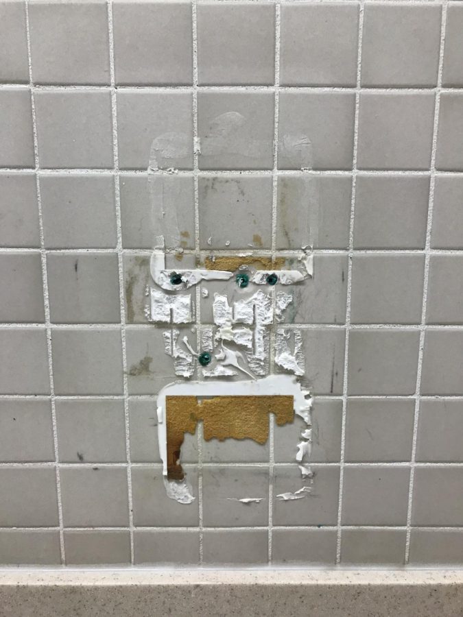 Photo of what once was a soap dispenser in the Commons Bathroom 
