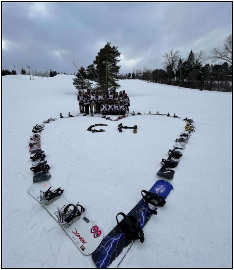 Snowboarding team supporting team member Chloe Howard.