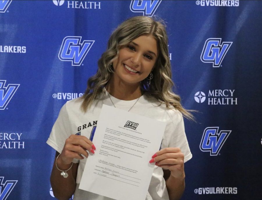 Maddie holding her commitment papers