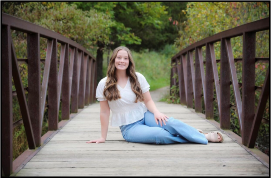 Erin Scheske posing for a Senior photo on a Kensington Metroparks bridge.