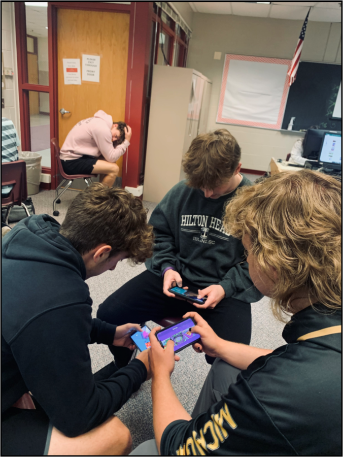 Seniors Ethan Groh (left), Zack Bonza-Brodie (right), Ryan Hanlin (middle) playing games together leaving senior Jett Edson alone (Photo by Izzi Putrus).
