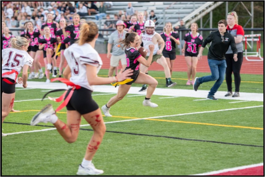 Senior Veronica Ricci, running the ball up the field.