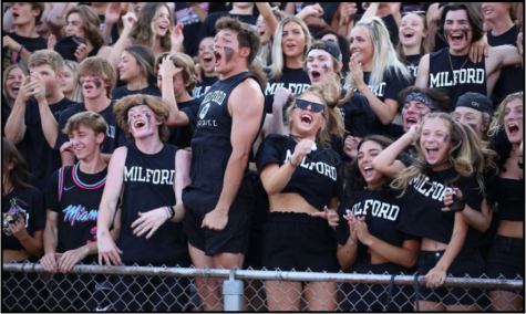 Seniors cheering on the Milford varsity football team on black out night (Photo courtesy of Milford Yearbook).
