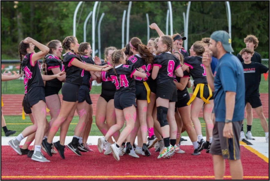 Senior and sophomore team celebrating a touchdown 