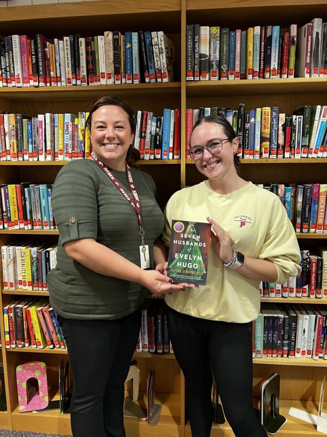 Book club sponsor Kelsey Breen (left) and book club President Angelina Maruskin (right) with the September book (Photos by Alexis Cornett).