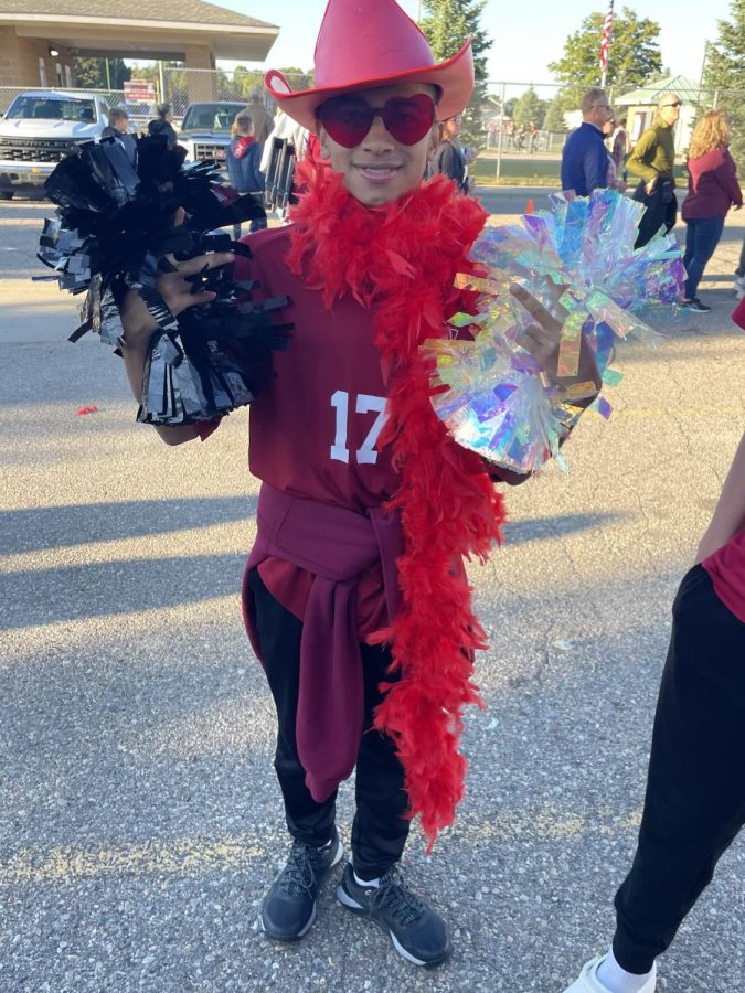 Angel Diequez attending Milford’s 2022 homecoming football game wearing his red sophomore gear