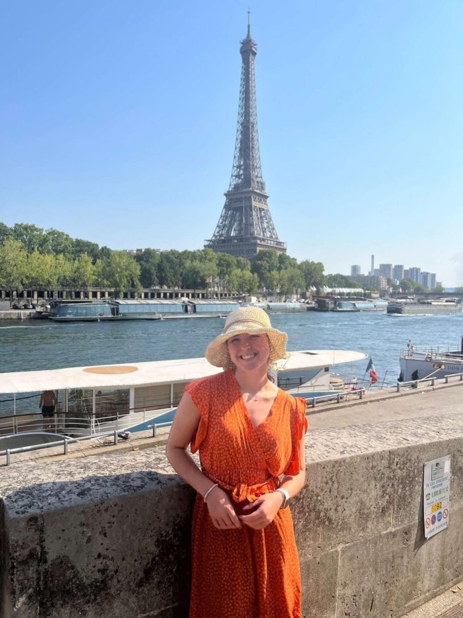 Angelia Maruskin posing for a photo in front of the Eiffel Tower.
