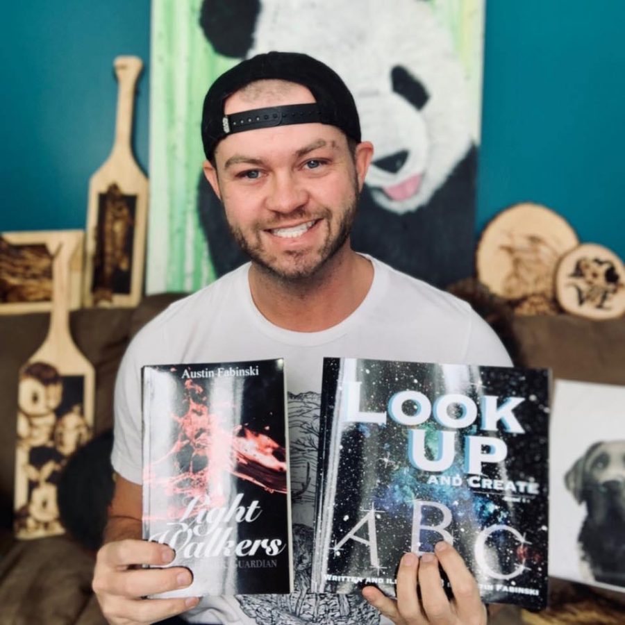 Fabinski with two of his published books, Look Up ABC and Light Walkers.