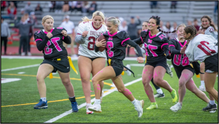 Senior Lizzie Thornton running with the ball  as her teammates follow behind her (All photos courtesy of  Jerry Rea Photography).
