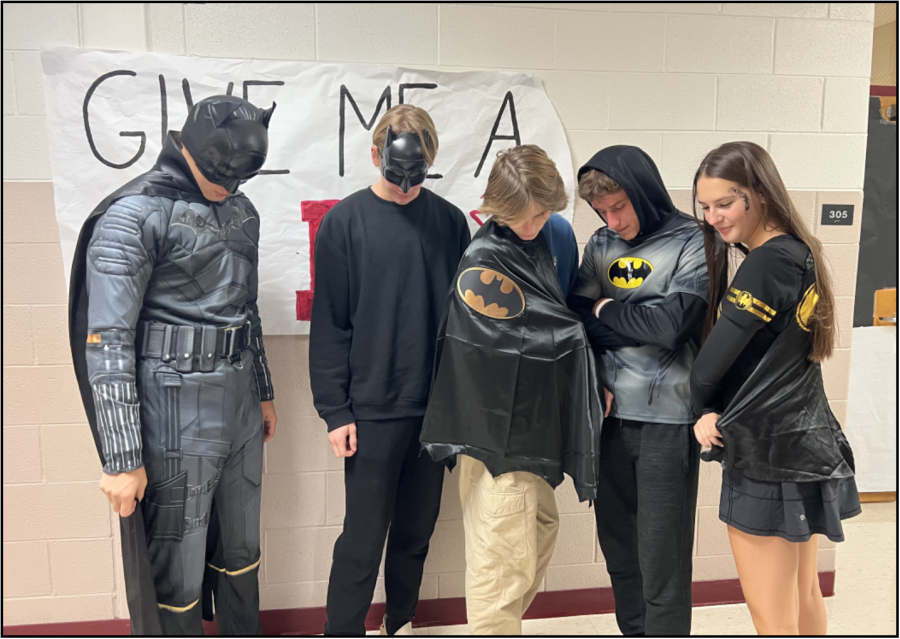 Seniors wearing Batman outfits on Superhero Day.

