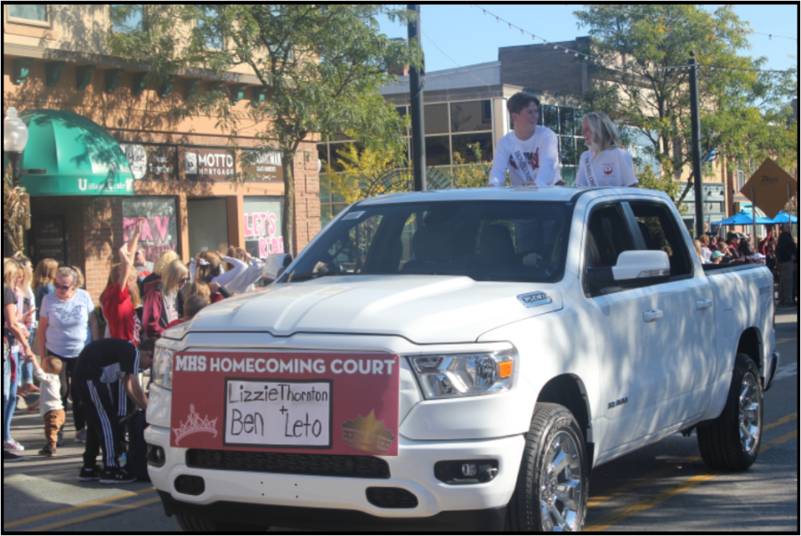 Seniors Lizzie Thornton and Ben Leto riding with the royal court during the Homecoming Parade.
