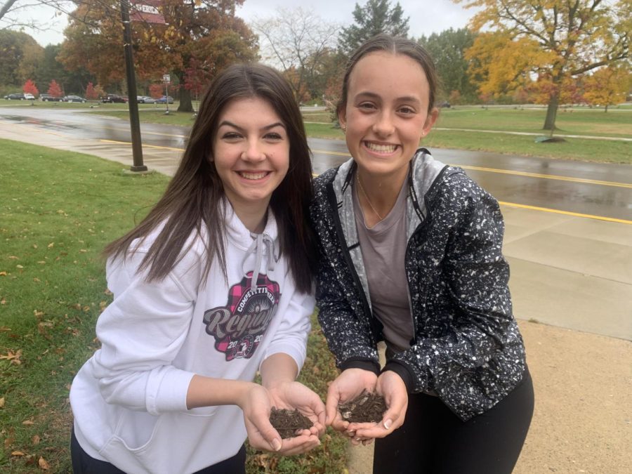 Seniors Leah Fitzgerald (left) and Caroline Colt (right) immerse themselves in nature and learn more about soil degradation
