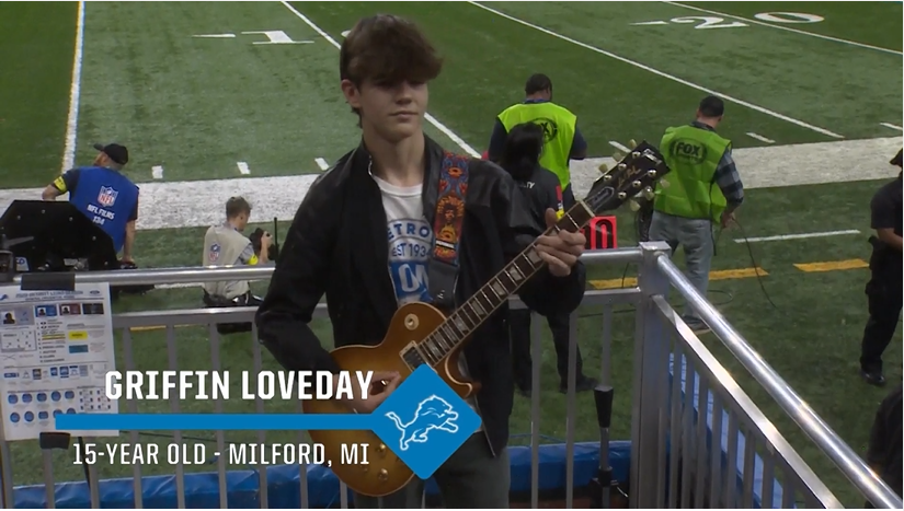 Griffin Loveday on stage during Detroit Lions Halftime show, playing Guns N’ Roses song for the fans at Ford Field.