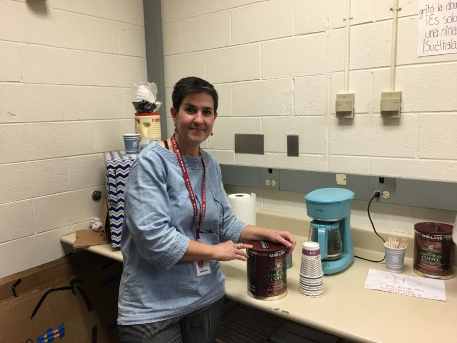 Profe alongside the coffee and other materials she has provided for her first hour students.