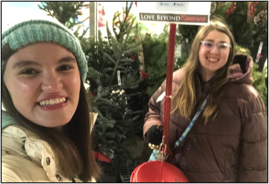 Juniors Emily Hilliard and Ayla Jednacz raise money for those in need during bell ringing outside of the Milford Kroger.