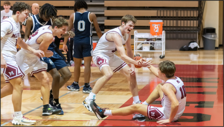 Sam Lewis helps up Owen Stark after a big basket and the foul. (Photo courtesy of Jerry Rea Photography).