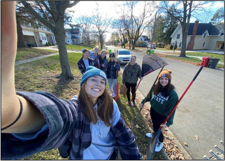 Students+gather+for+a+group+picture+after+raking+a+yard+%28Photo+courtesy+of+Courtney+Drew%29