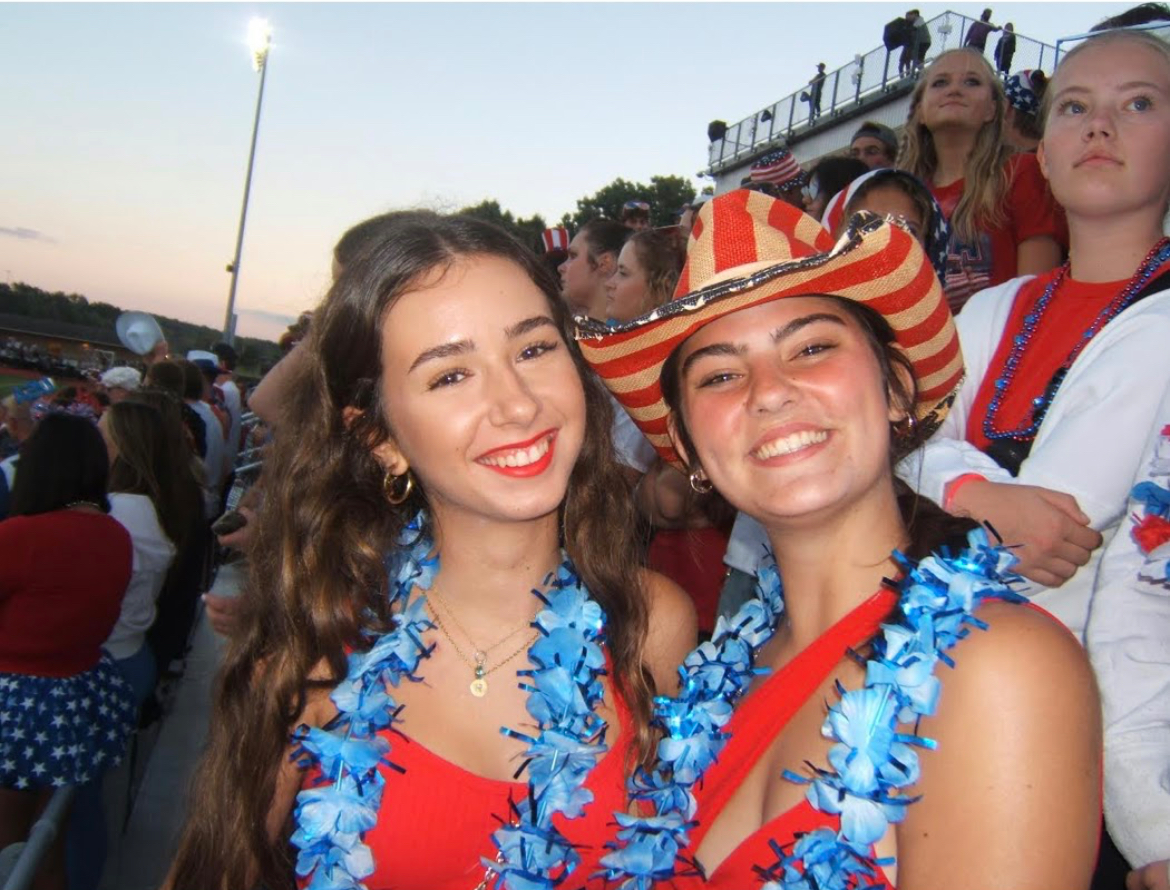 Julia Alarcón-Giménez (left) and Aleah Partyka (right) enjoying the Milford vs South Lyon football game.